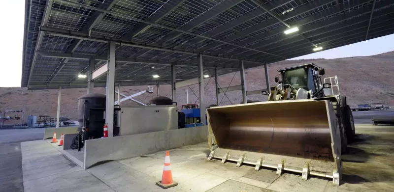 Bulldozer under a PowerShingle mining solar energy canopy